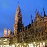 The illuminated Munich city hall at Marienplatz, the cathedral towers in the background