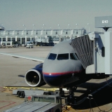 A United Airlines airplane connected to a pedestrian tube at the terminal