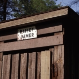 An old wooden toilet next to the ski jumping tower