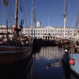 Old sail boats in Kolera-allas, the city hall in the background