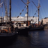 Old sail boats in Kolera-allas, the city hall in the background