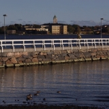 Suomenlinna sea fortress seen from Kaivopuisto park, the Ullanlinna pier on the foreground