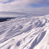 Shapes in the snow on the slope of Vuomap, Saariselk's other hills in the background