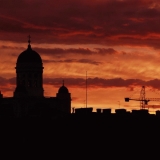 Sun sets behind Helsinki's roofs