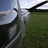 The sky reflects from the windshield of an experimental airplane