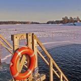 A winter time open water swimming place at Marjaniemi beach, Koivusaari islands in the background