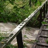 A bridge goes over a flooding creek