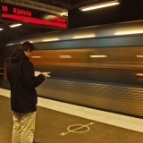 A subway train passing by a station