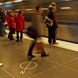 A subway train passing by a station