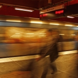 A subway train passing by a station