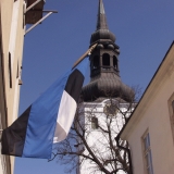 The Estonian flag and the tower of Tallinn cathedral