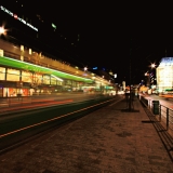 A tram passing Lasipalatsi station at Mannerheimintie