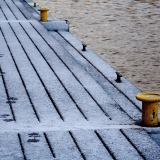 Footprints on a snowy pier