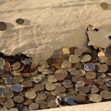 Coins at a rainwater sewer at the top of the Stadium tower