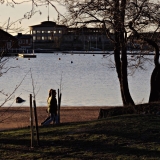 A couple on a walk at Uunisaari island, Sirpalesaari island in the background