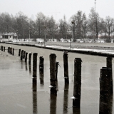 A boat platform and poles on a snowy afternoon