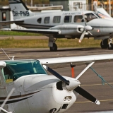 Piper owned by FM-Kartta Oy, a small Cessna in the foreground