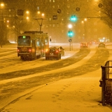 Cars and a tram in a blizzard at Mannerheimintie