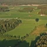 The shadow of a hot air balloon in a farmland scenery