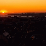 Sun sets in the Espoo archipelago, western Helsinki in the foreground