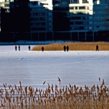 People walking on ice in front of Lehtisaari