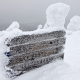 A sign with distances at the top of Valtavaara