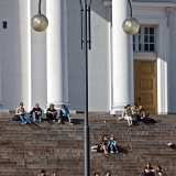 People enjoying a summer day at the steps of the Helsinki cathedral