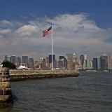 Stars and stripes on Ellis Island, Manhattan in the background