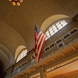 Stars and stripes hanging in a large hall at Ellis Island