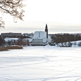 The tower of the national museum of Finland blends to the wall of Finlandia Hall