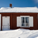 A cabin covered in snow