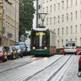 A tram and a police car pass each other at Tehtaankatu