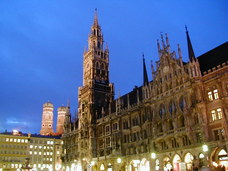 The illuminated Munich city hall at Marienplatz, the cathedral towers in the background