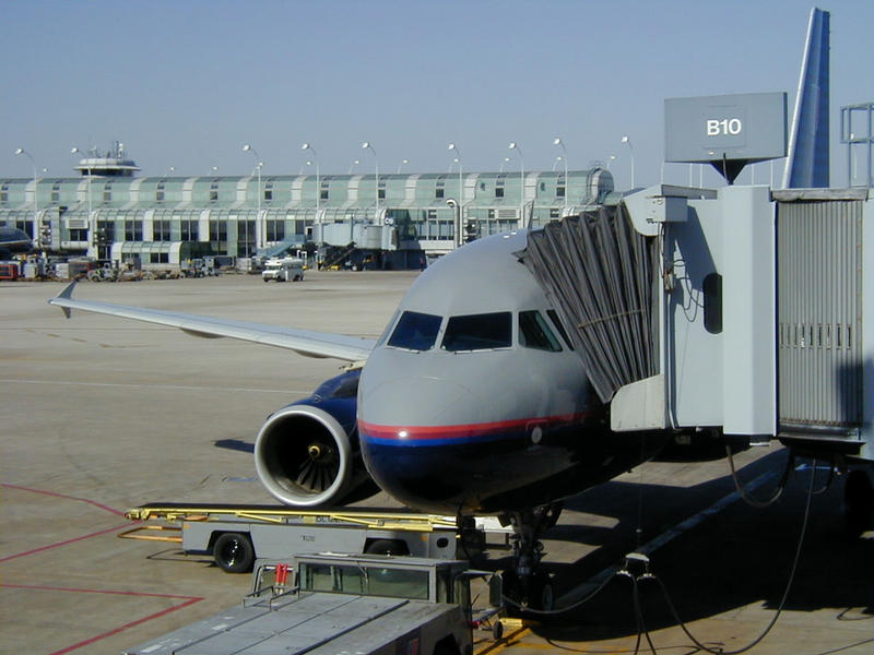 A United Airlines airplane connected to a pedestrian tube at the terminal