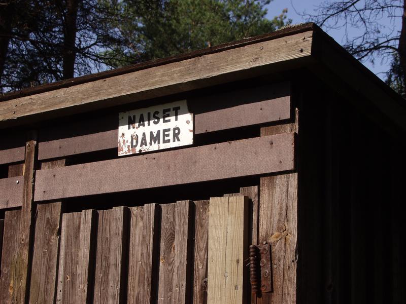 An old wooden toilet next to the ski jumping tower