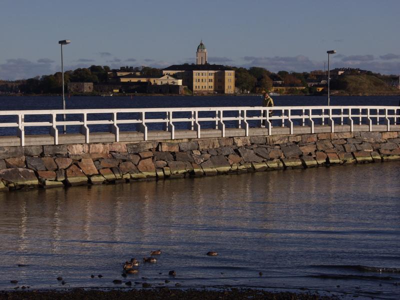 Suomenlinna sea fortress seen from Kaivopuisto park, the Ullanlinna pier on the foreground