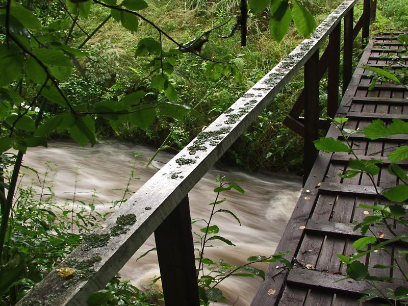 A bridge goes over a flooding creek