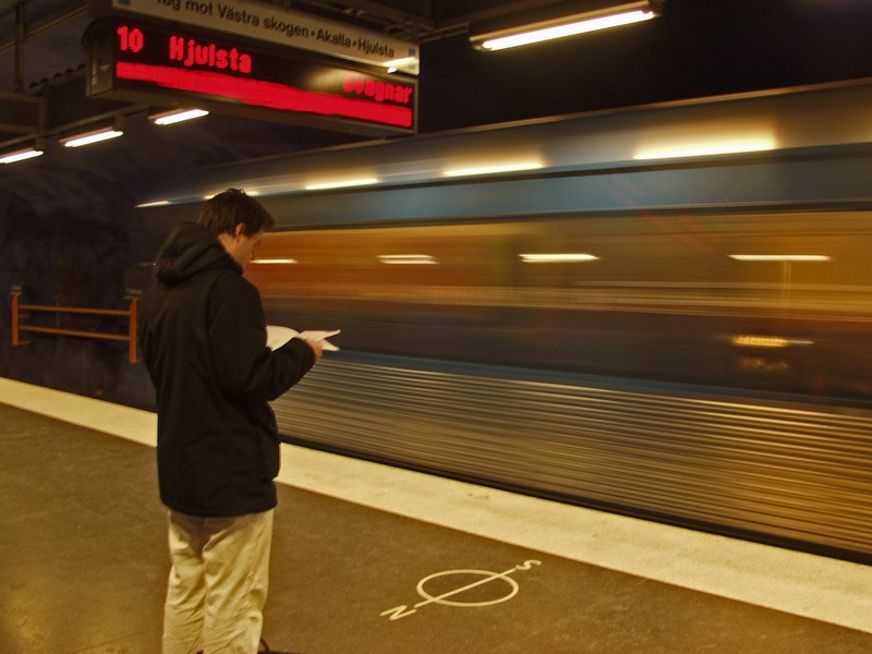 A subway train passing by a station