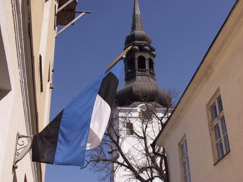 The Estonian flag and the tower of Tallinn cathedral