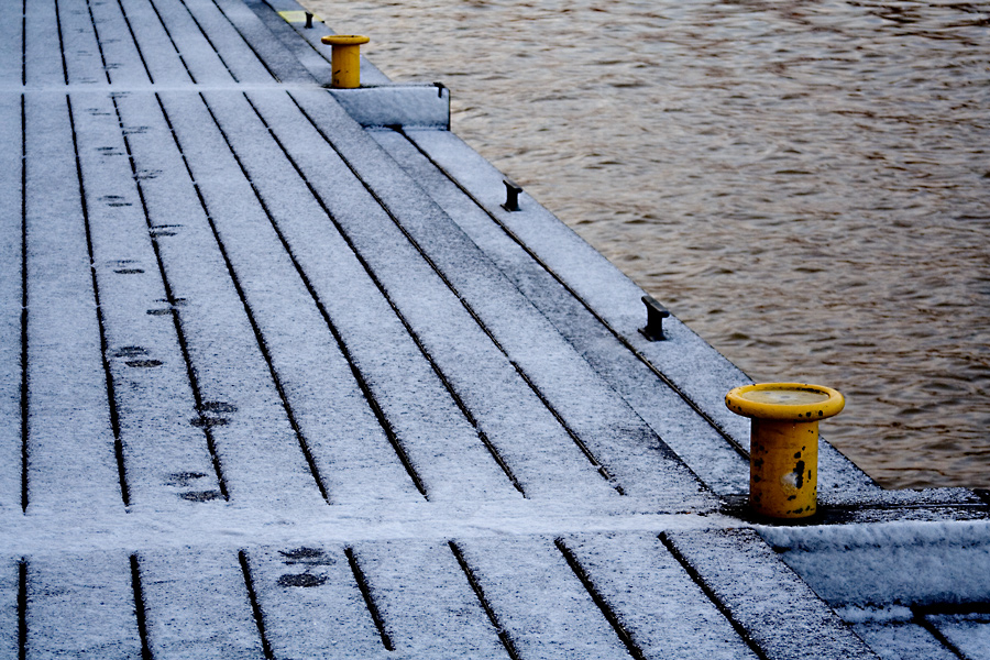 Footprints on a snowy pier
