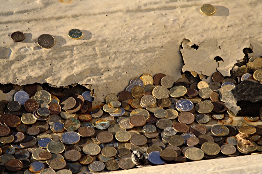 Coins at a rainwater sewer at the top of the Stadium tower