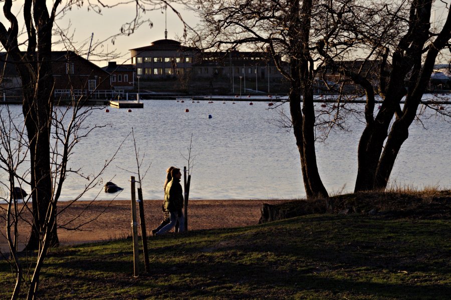 A couple on a walk at Uunisaari island, Sirpalesaari island in the background