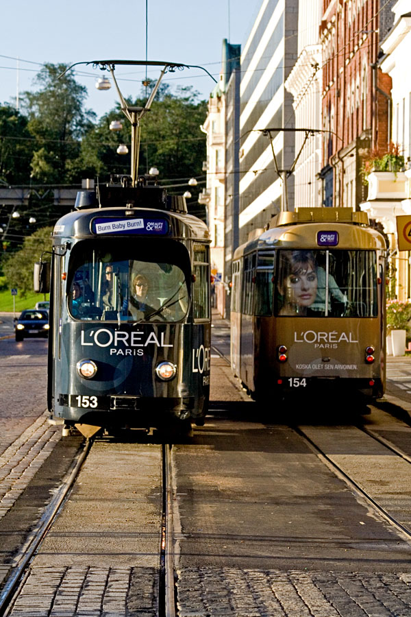 Trams advertising L'oreal passing each other