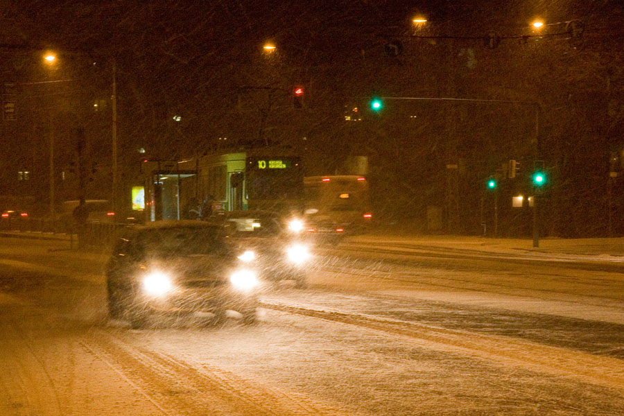 Cars and a tram in a blizzard at Mannerheimintie