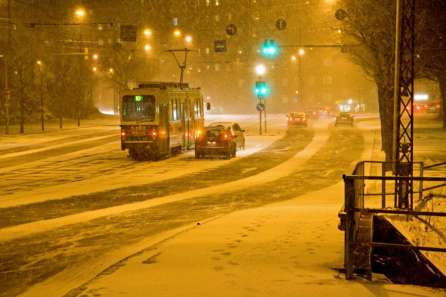 Cars and a tram in a blizzard at Mannerheimintie