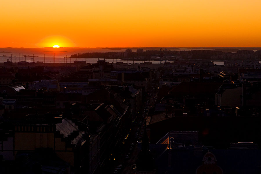 Sun sets in the Espoo archipelago, western Helsinki in the foreground