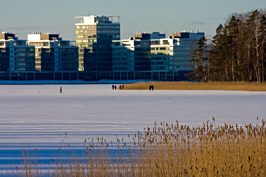People walking on ice in front of Lehtisaari