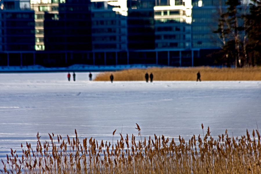 People walking on ice in front of Lehtisaari