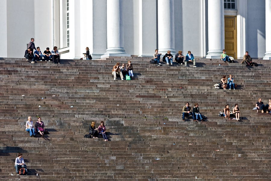 People enjoying a summer day at the steps of the Helsinki cathedral