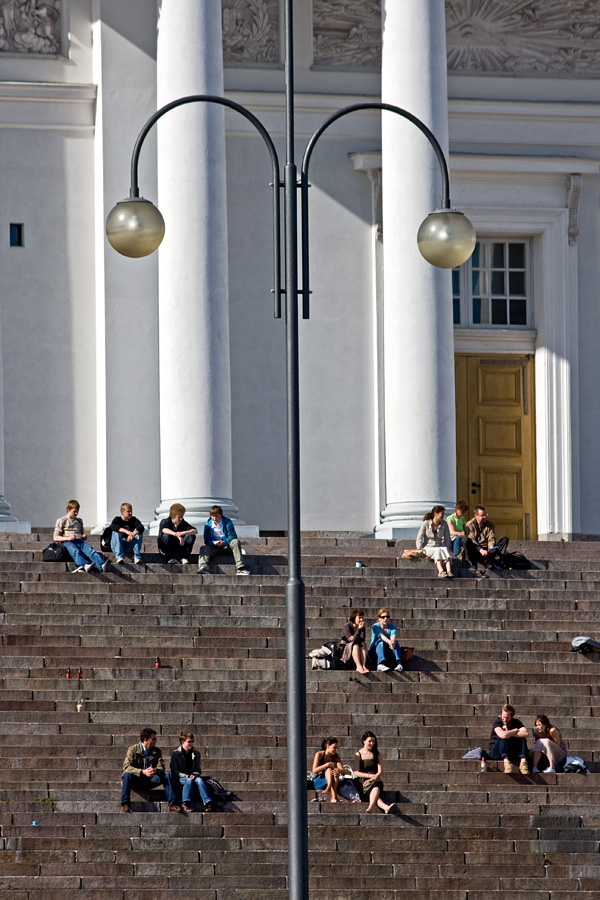 People enjoying a summer day at the steps of the Helsinki cathedral